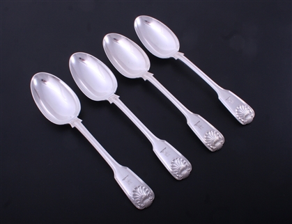 A set of four Victorian fiddle, thread and shell pattern sterling silver table spoons