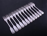 A set of twelve Irish Victorian fiddle, thread and shell pattern sterling silver table forks