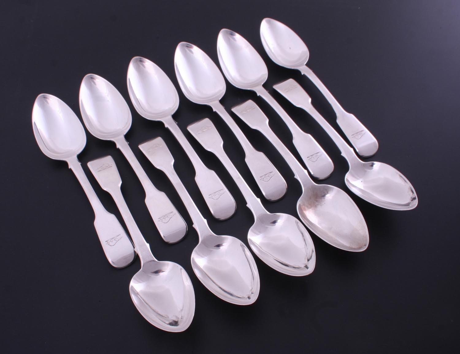 A set of eleven IV sterling silver fiddle pattern dessert spoons