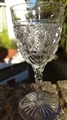 A set of cut glass armorial sherry glasses and a bowl