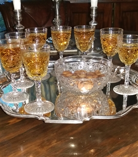 A set of cut glass armorial sherry glasses and a bowl