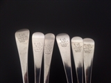 A matched set of six George III Old English pattern sterling silver table spoons