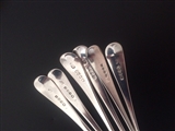 A matched set of six George III Old English pattern sterling silver table spoons