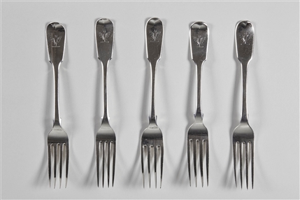 A matched set of five antique fiddle pattern sterling silver dessert forks